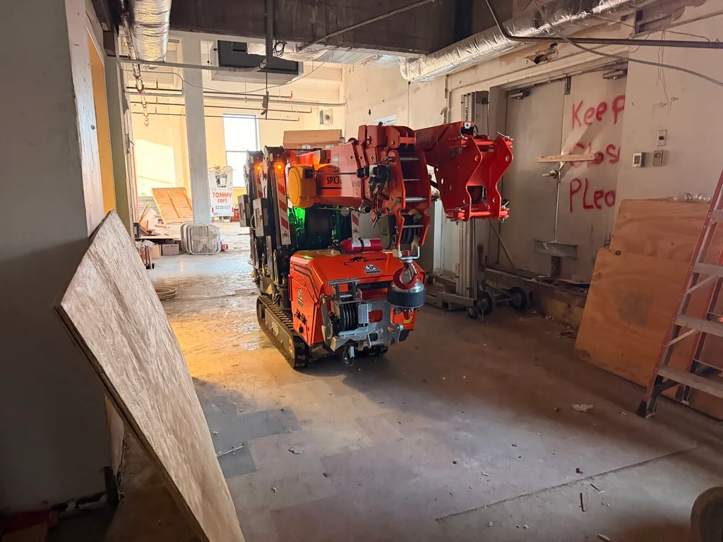 Jekko SPX328 battery mini crane working inside a building under renovation